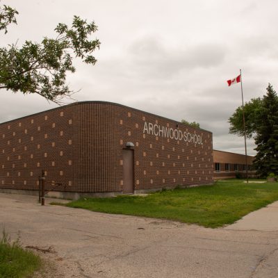 Photo of frontside of Archwood School at 800 Archibald Street, showing brick detail and sign
