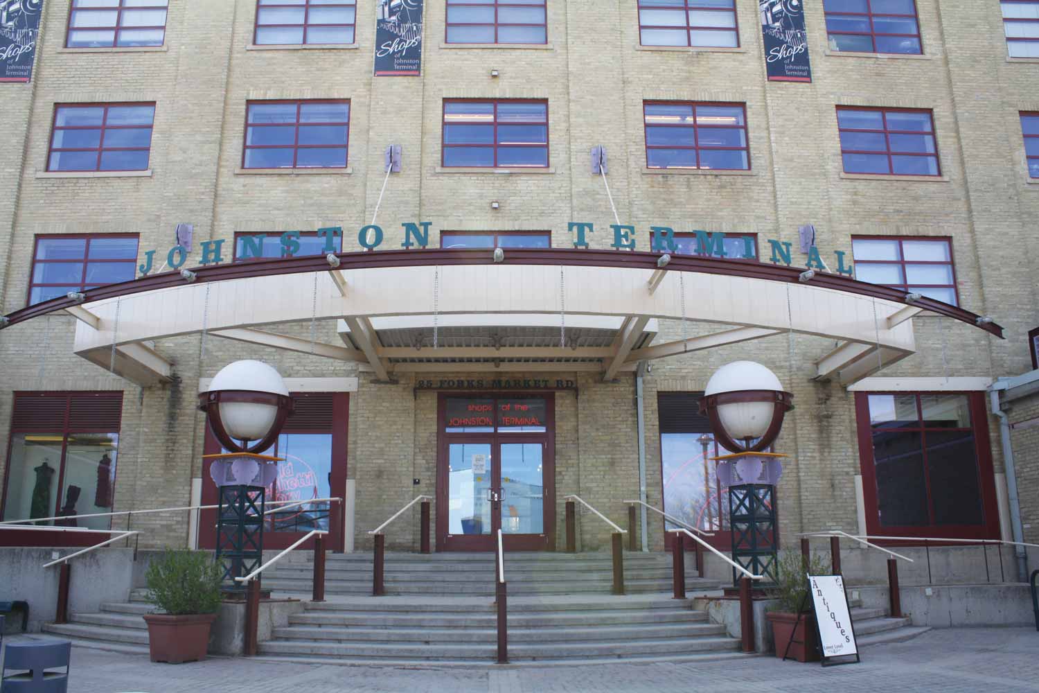 Entrance to Johnston Terminal, featuring a curved entrance canopy and stairs leading up to a door.