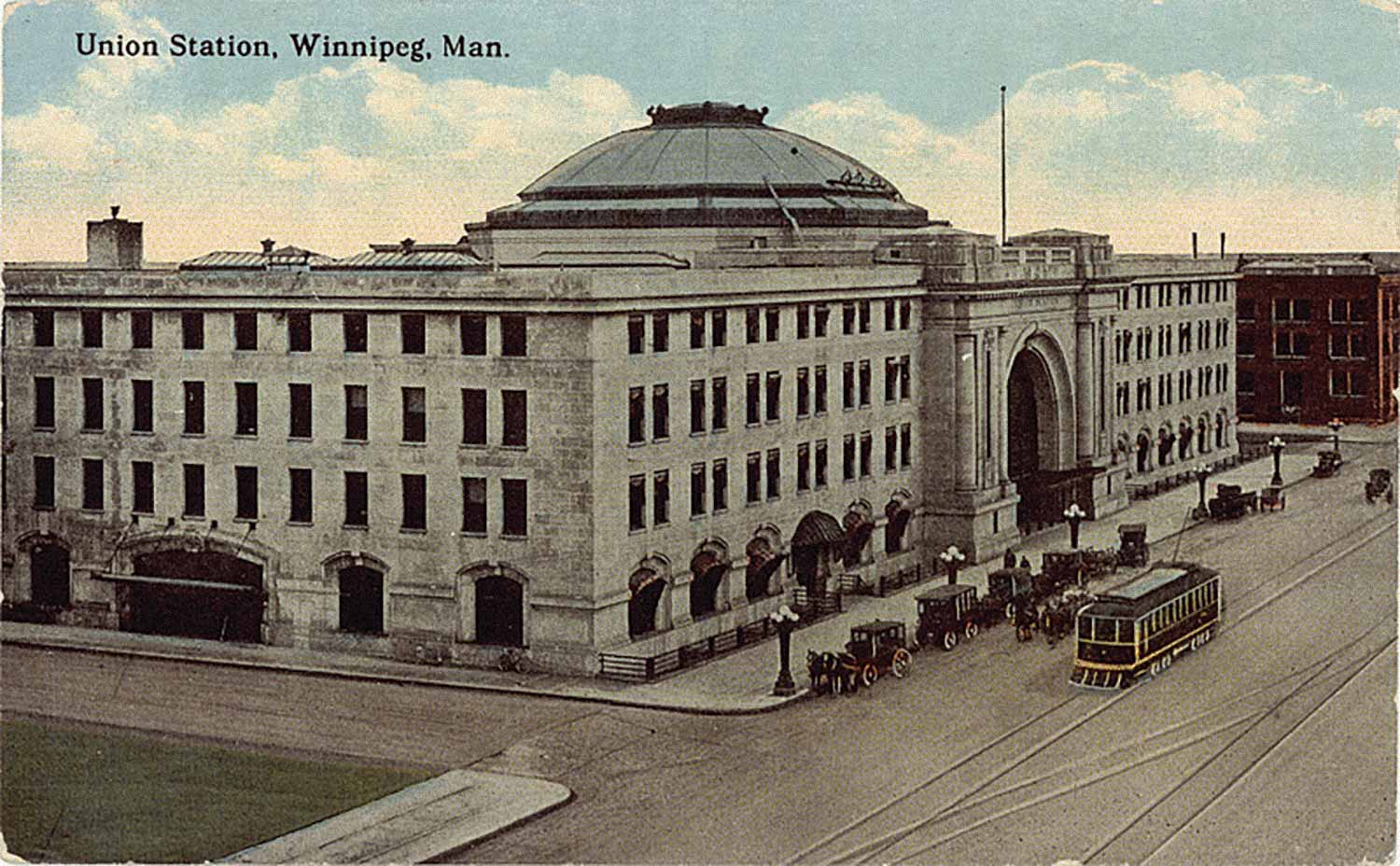 A colorized postcard showing Union Station with Main Street to the front.
