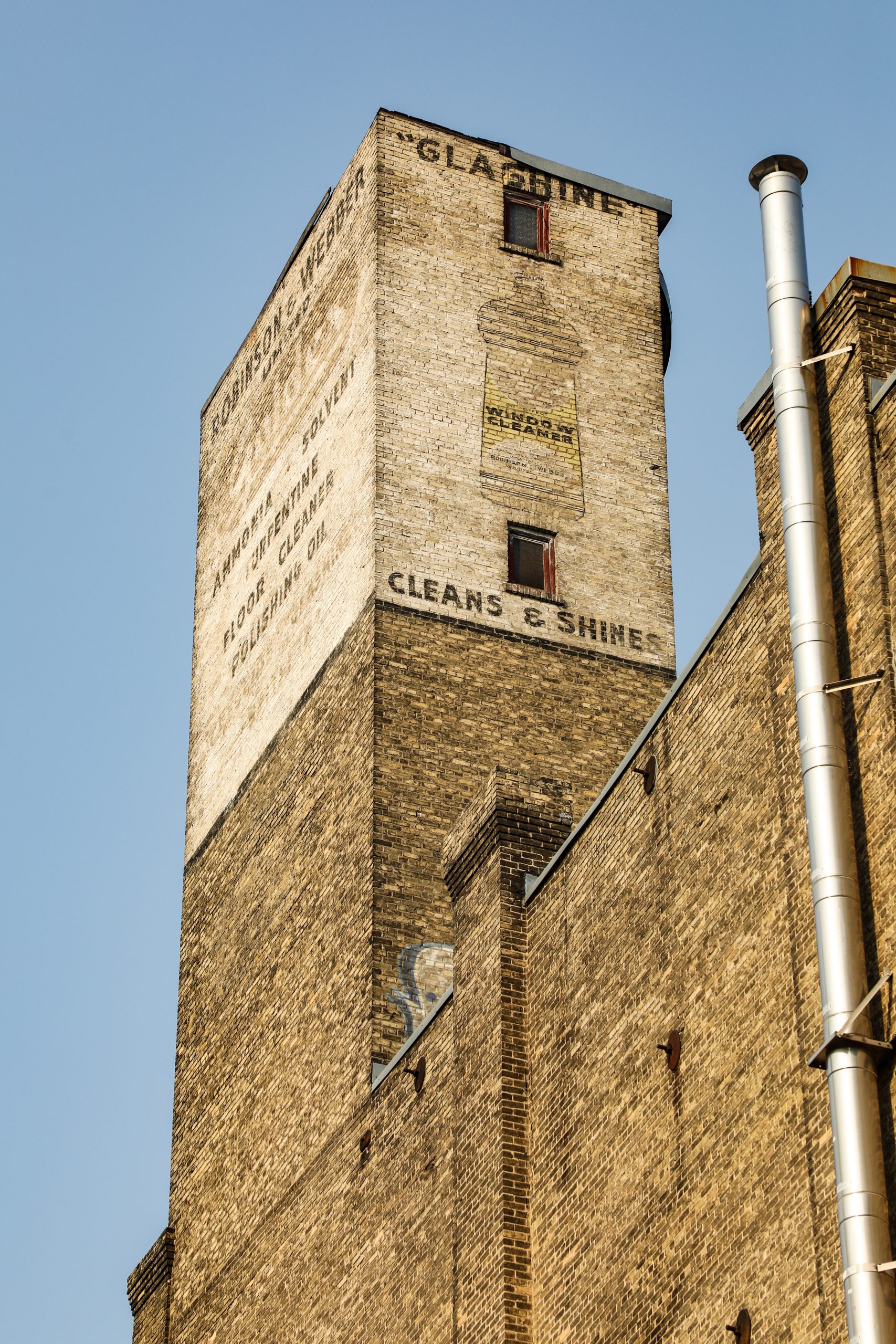 Photo of Robinson and Webber Ghost Signs on the watertower of the building at 185 Bannatyne.