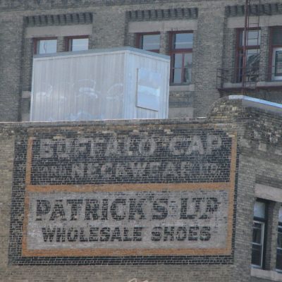 Buffalo Cap and Neckwear and Patrick's Limited Ghost Signs on building at 250 McDermot Ave.