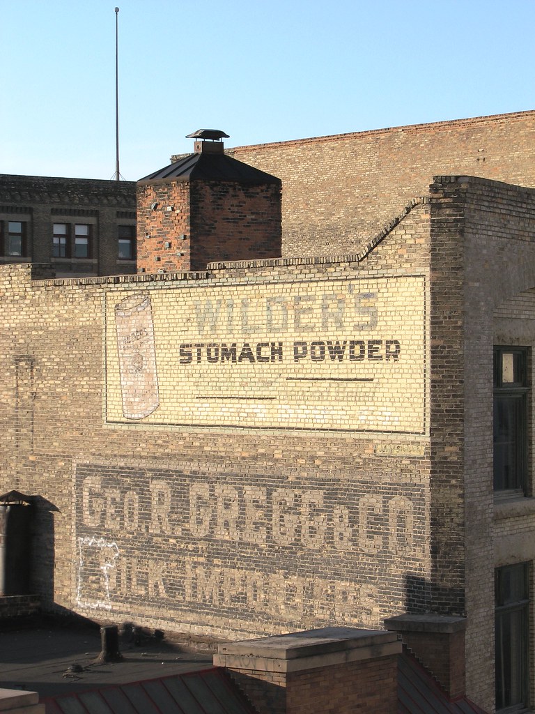 Close-up photo of Wilder's Stomach Powder and George R. Gregg & Co. Silk Imports ghost signs on Gregg Building at 52 Albert Street