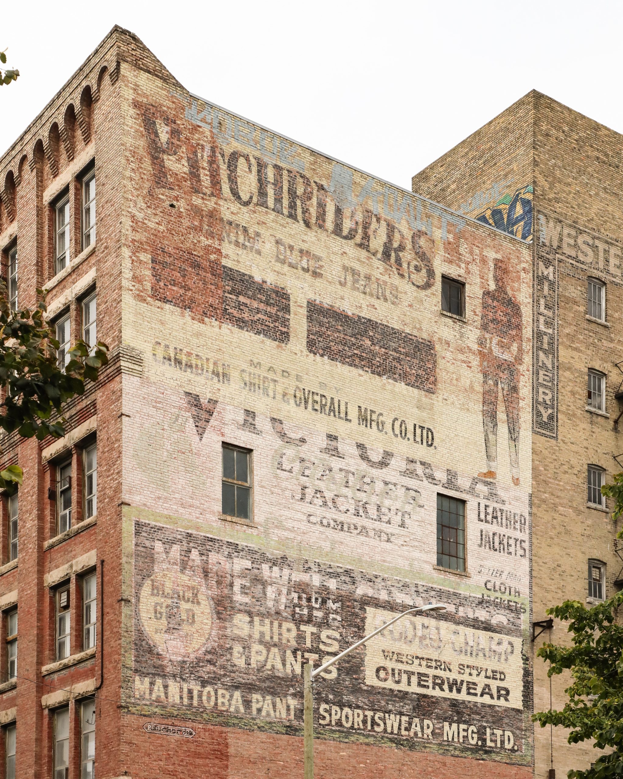 Photo of ghost signs on rear side of the Daylite building at 296 McDermot Avenue