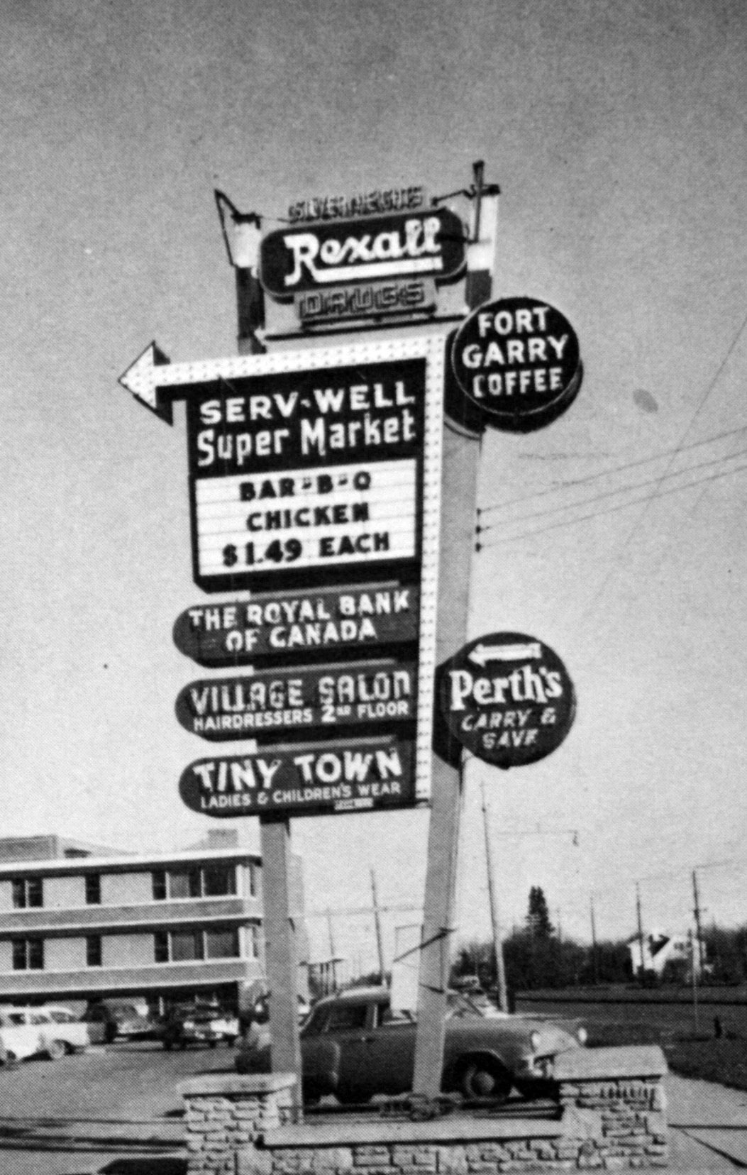 Image shows an archival photo of signage directing cars to the Silver Heights Shopping Centre.