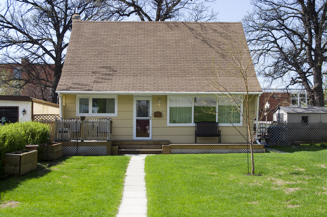 Image shows the exterior of a one-storey and yellow home.