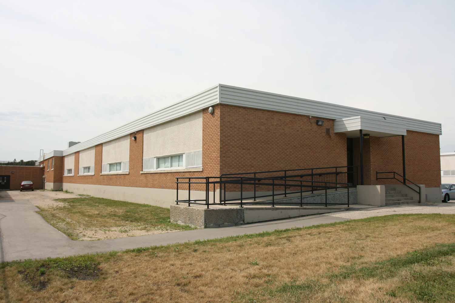 Image shows exterior of Strathmillan School, with small windows on the side.