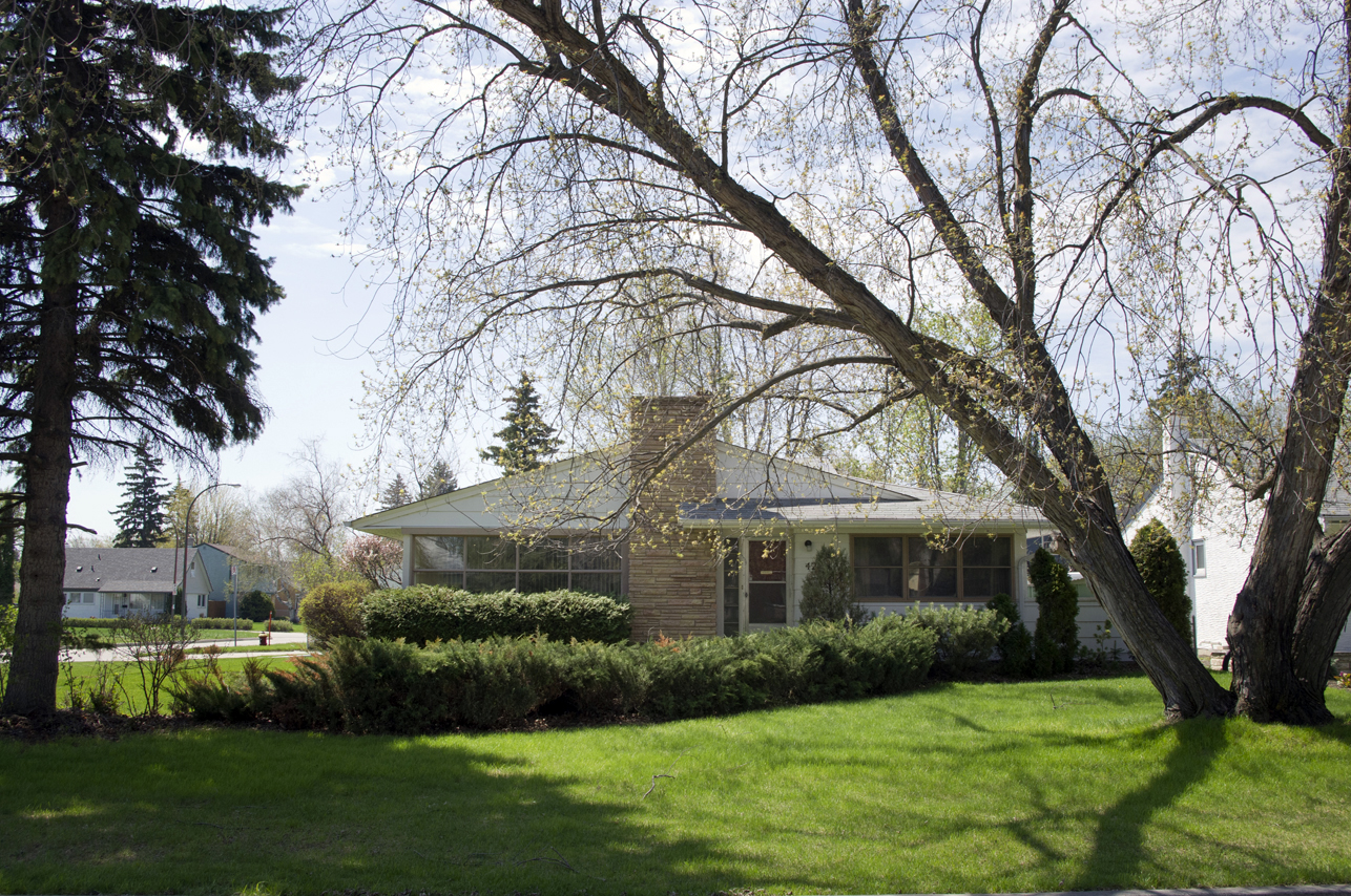 Image shows a one-storey home with a fireplace.