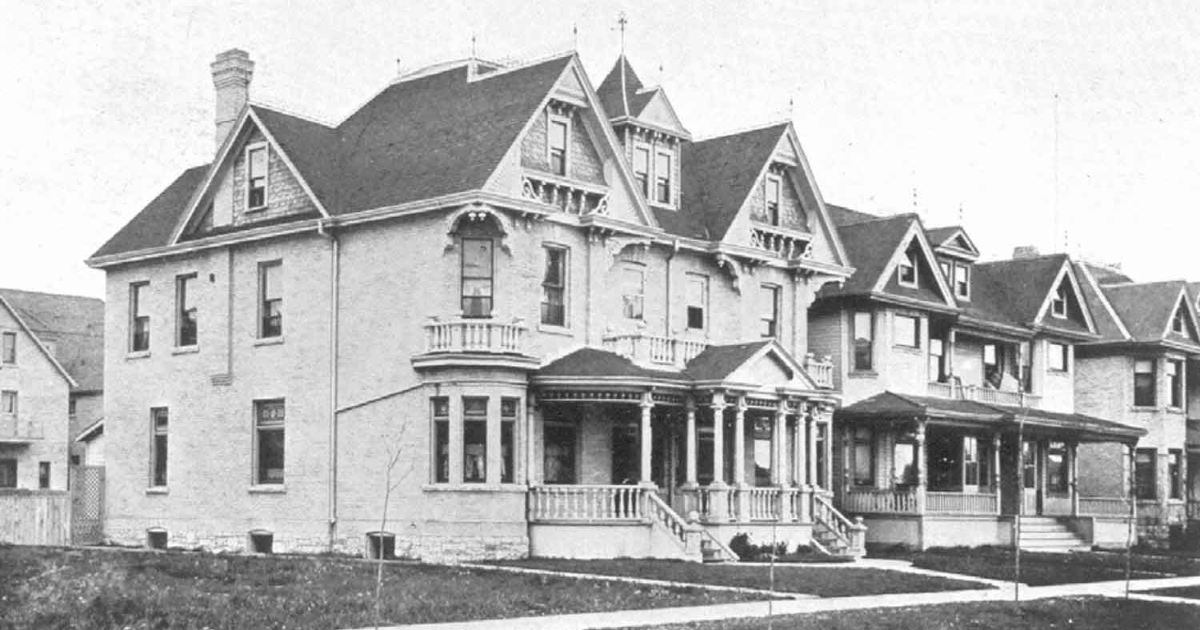 A black and white photograph of a row of historic houses on Edmonton Street in Winnipeg.