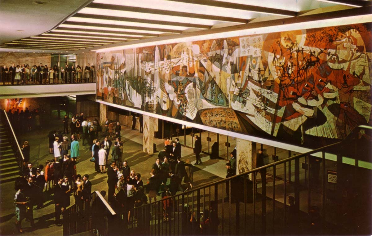 Image shows a mural overlooking a crowd of people.