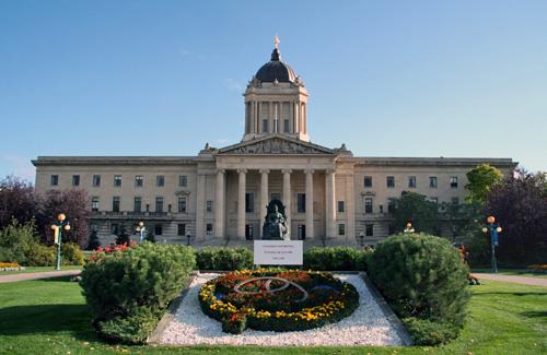 The exterior of the Manitoba Legislative Building in the summer.