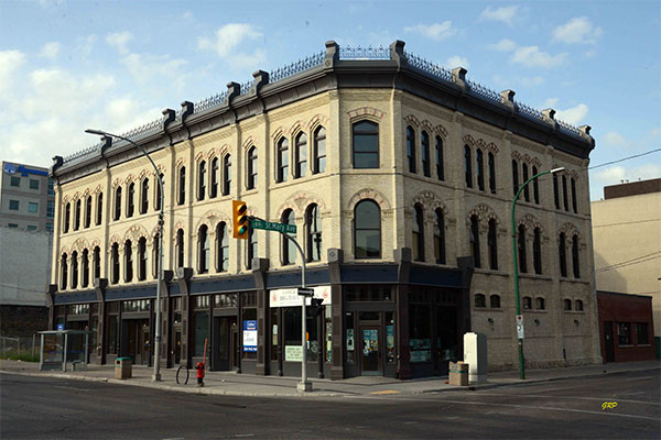 The now restored Fortune and Macdonald blocks. The building is beige with red and metal accents.